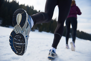 Image showing couple jogging outside on snow