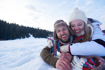 Image showing couple having fun and walking in snow shoes