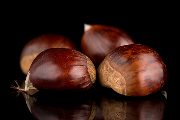 Image showing Chestnuts on a black reflective background