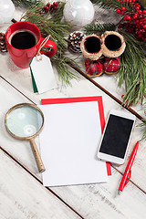 Image showing The blank sheet of paper on the wooden table with a pen 