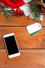 Image showing The wooden table with a phone