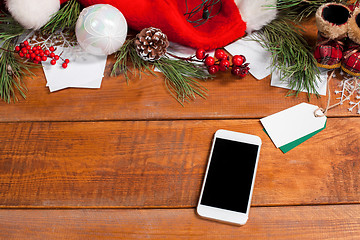 Image showing The wooden table with a phone