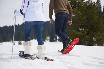 Image showing couple having fun and walking in snow shoes