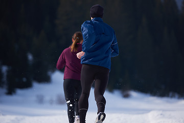 Image showing couple jogging outside on snow