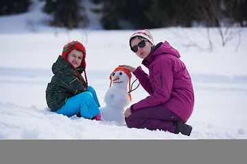 Image showing happy family building snowman