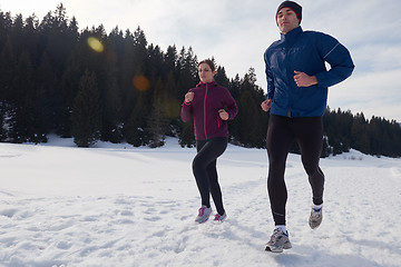 Image showing couple jogging outside on snow