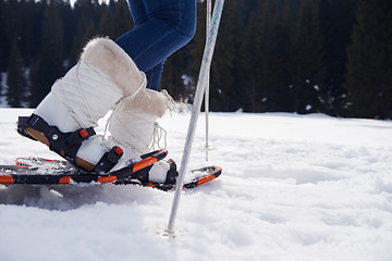 Image showing couple having fun and walking in snow shoes