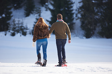 Image showing couple having fun and walking in snow shoes