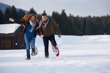 Image showing couple having fun and walking in snow shoes