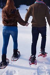 Image showing couple having fun and walking in snow shoes