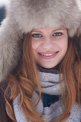 Image showing portrait of beautiful young redhair woman in snow scenery