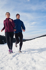 Image showing couple jogging outside on snow