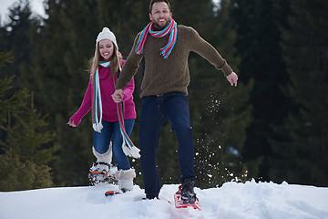 Image showing couple having fun and walking in snow shoes