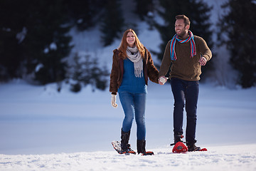 Image showing couple having fun and walking in snow shoes