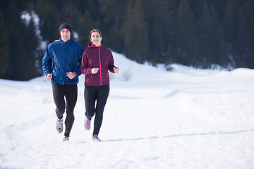 Image showing couple jogging outside on snow