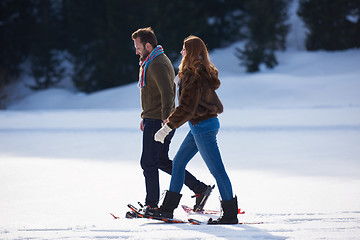 Image showing couple having fun and walking in snow shoes