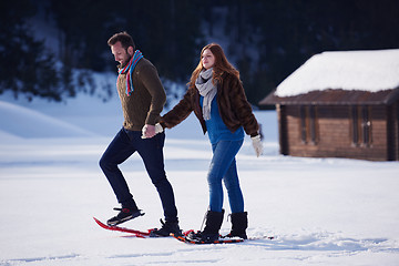 Image showing couple having fun and walking in snow shoes