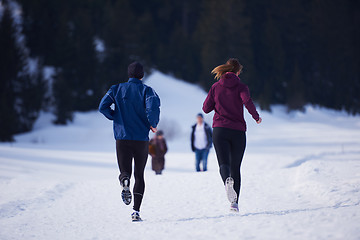 Image showing couple jogging outside on snow