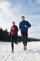 Image showing couple jogging outside on snow