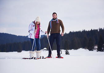 Image showing couple having fun and walking in snow shoes