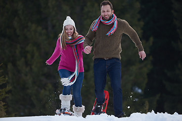 Image showing couple having fun and walking in snow shoes