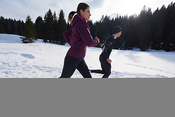 Image showing couple jogging outside on snow