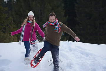 Image showing couple having fun and walking in snow shoes