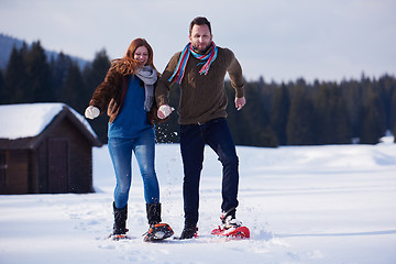 Image showing couple having fun and walking in snow shoes