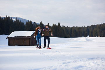 Image showing couple having fun and walking in snow shoes