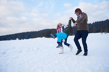 Image showing happy family playing together in snow at winter