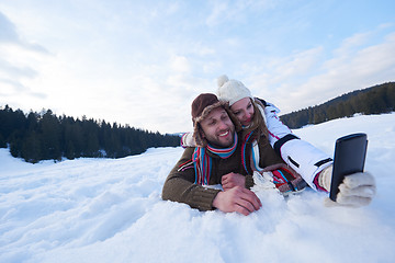 Image showing romantic couple have fun in fresh snow and taking selfie