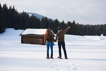 Image showing couple having fun and walking in snow shoes