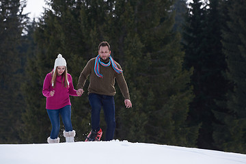 Image showing couple having fun and walking in snow shoes