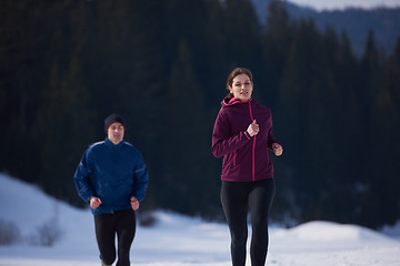 Image showing couple jogging outside on snow