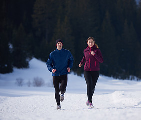 Image showing couple jogging outside on snow