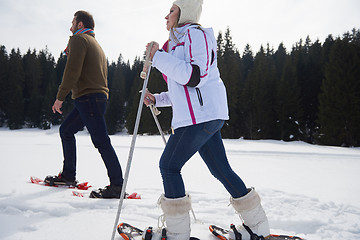 Image showing couple having fun and walking in snow shoes