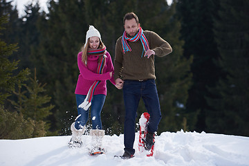 Image showing couple having fun and walking in snow shoes