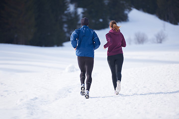 Image showing couple jogging outside on snow