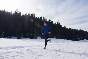 Image showing jogging on snow in forest