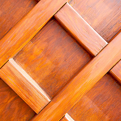 Image showing home texture of a brown antique wooden old door in italy   europ