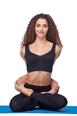 Image showing Studio shot of a young fit woman doing yoga exercises.