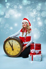 Image showing Girl dressed in santa hat with a Christmas decorations  