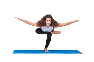 Image showing Studio shot of a young fit woman doing yoga exercises.