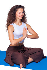 Image showing Studio shot of a young fit woman doing yoga exercises.