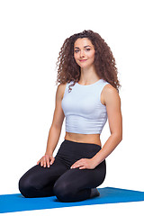 Image showing Studio shot of a young fit woman after yoga exercises.