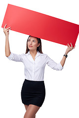 Image showing Businesswoman holding a banner