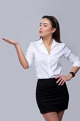 Image showing business woman blowing on palm