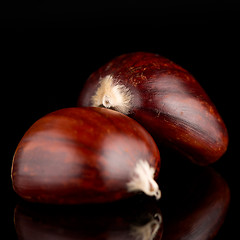 Image showing Chestnuts on a black reflective background