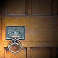 Image showing handle in london antique brown door  rusty  brass nail and light