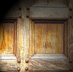 Image showing abstract texture of a brown antique wooden old door in italy   e